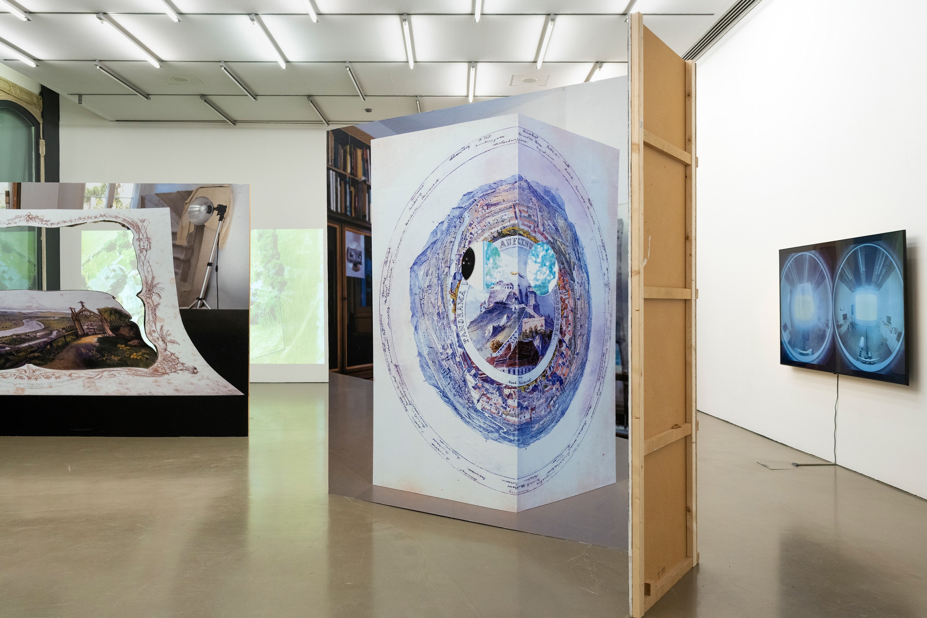 Panorama (Reichert/Kurz), 250 cm x 330 cm, blue back poster on wood, 2024<br />Recto/Verso 360°, video, sound, 4’54‘‘, 2017<br />Installation view Prospect, Camera Austria, 2024<br />Photography: Markus Krottendorfer